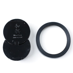 Bakc of the Sun and Moon black kenzan next to rubber gasket