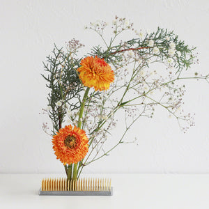 Kenzan with orange flower composition