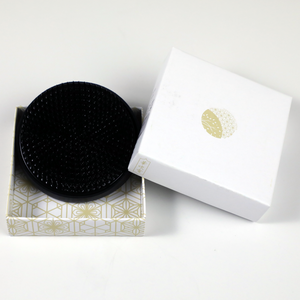 Black round kenzan in its original box