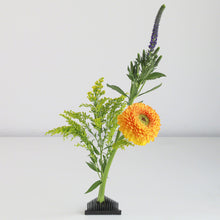 Load image into Gallery viewer, Small flower arrangement on a black triangle kenzan
