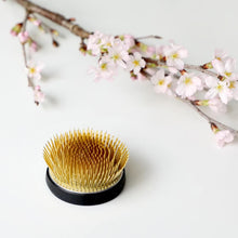 Load image into Gallery viewer, Radial kenzan posing next to a branch with cherrym blossom flowers
